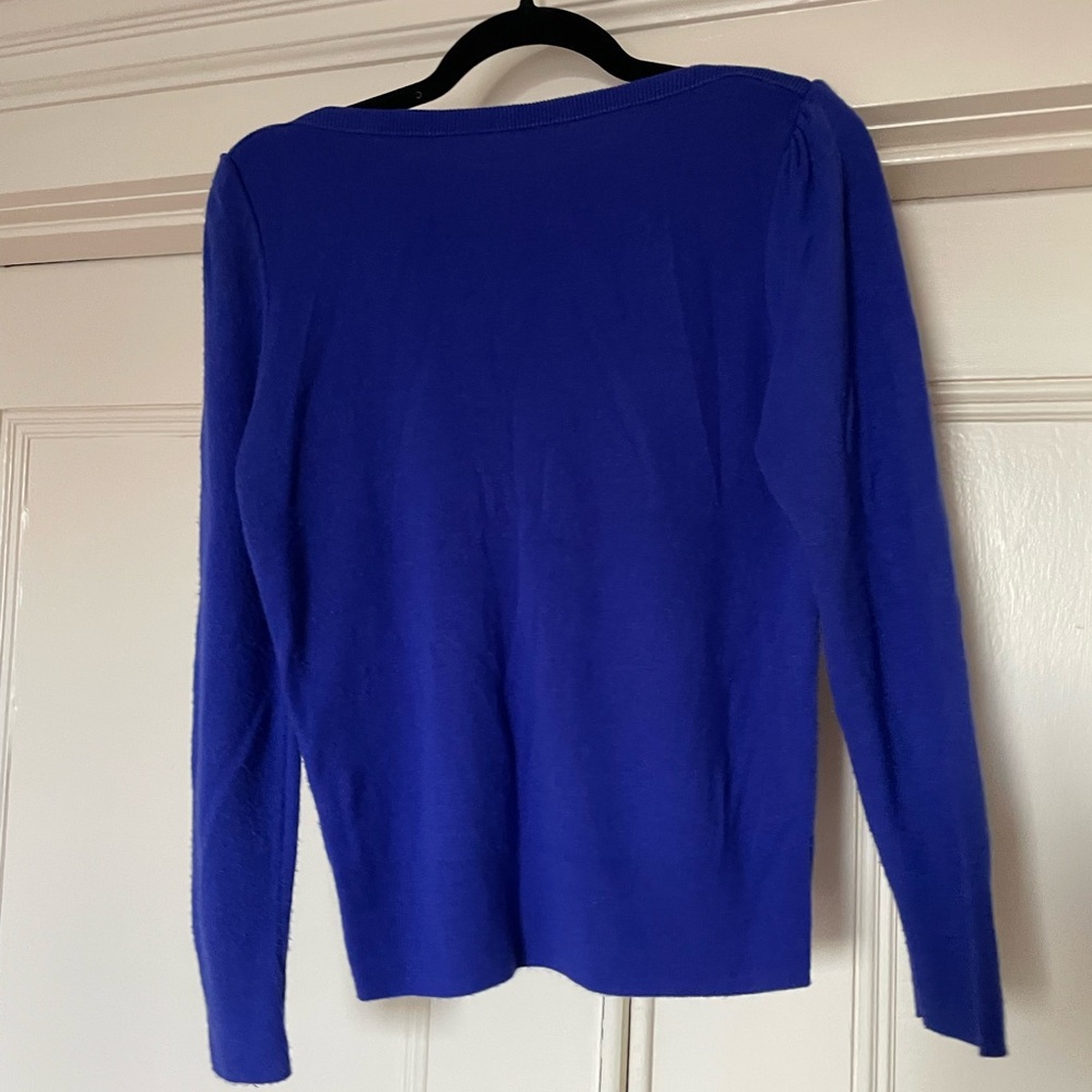 A royal blue sweater with shoulder detail